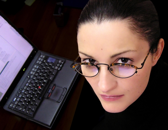 a Hispanic job seeker next to her computer