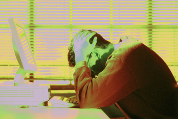 4 ways to Avoid Becoming a Workaholic represented by a frustrated employee