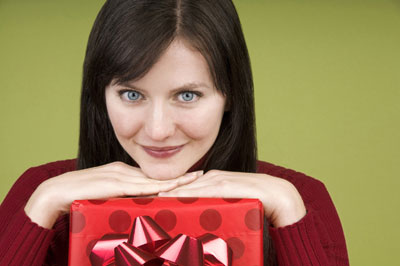 A lady smiling with a gift