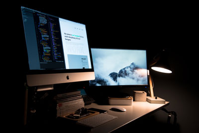 A desk with a laptop and computer monitor