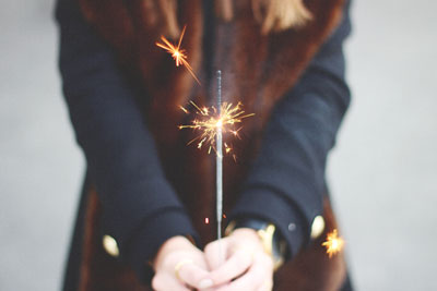 A woman holding a sparkler