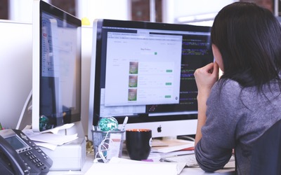 A woman looking at her computer screen