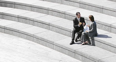 Person in business clothes sitting on steps