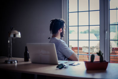 a person staring out of the window in their office