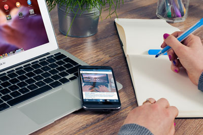 A desk with a laptop and phone