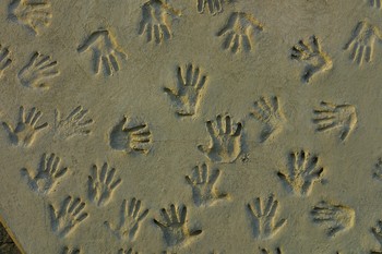 using twitter to impress people represented by hand prints in the sand