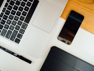 A laptop and smartphone on a desk