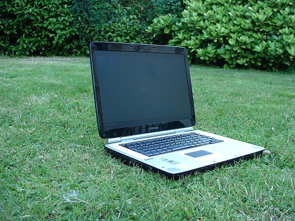 A laptop on a field working remotely