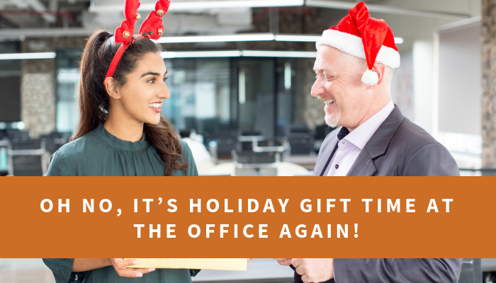 Two office workers smiling with Santa hats on