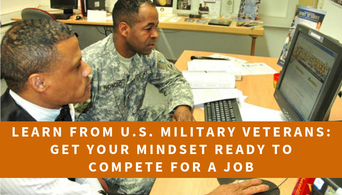 U.S. Military Veteran seated a computer with another person